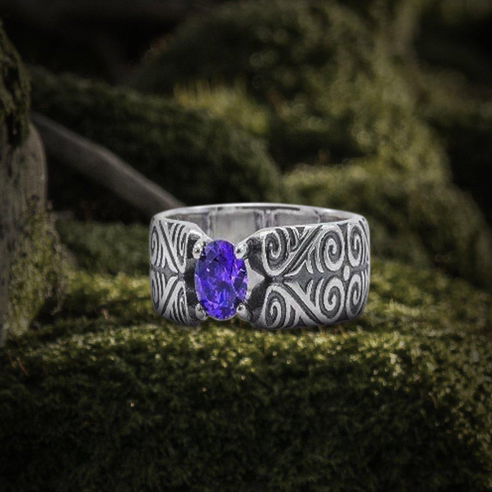 Handcrafted 925 silver Viking ring with intricate scrollwork and an oval purple gemstone.