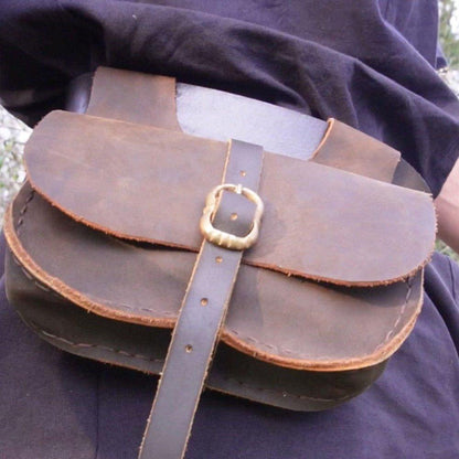 Authentic Viking brown leather belt bag with brass buckle closure, worn on a dark tunic.