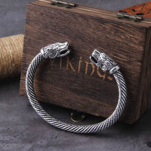Silver Viking forged steel torc bracelet with detailed dragon heads and a twisted band.