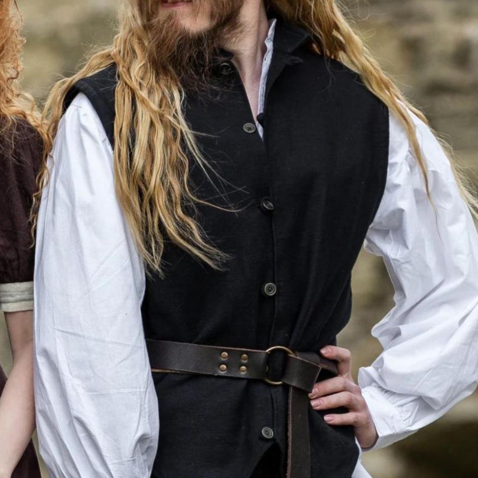 Black handwoven cotton Viking vest with metal button closure, worn over a white shirt and belted.