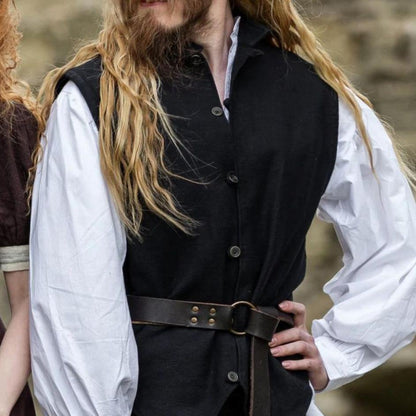 Black handwoven cotton Viking vest with metal button closure, worn over a white shirt and belted.