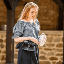 Viking-inspired blue off-shoulder short sleeve blouse with a black leather pouch and a decorative jug.