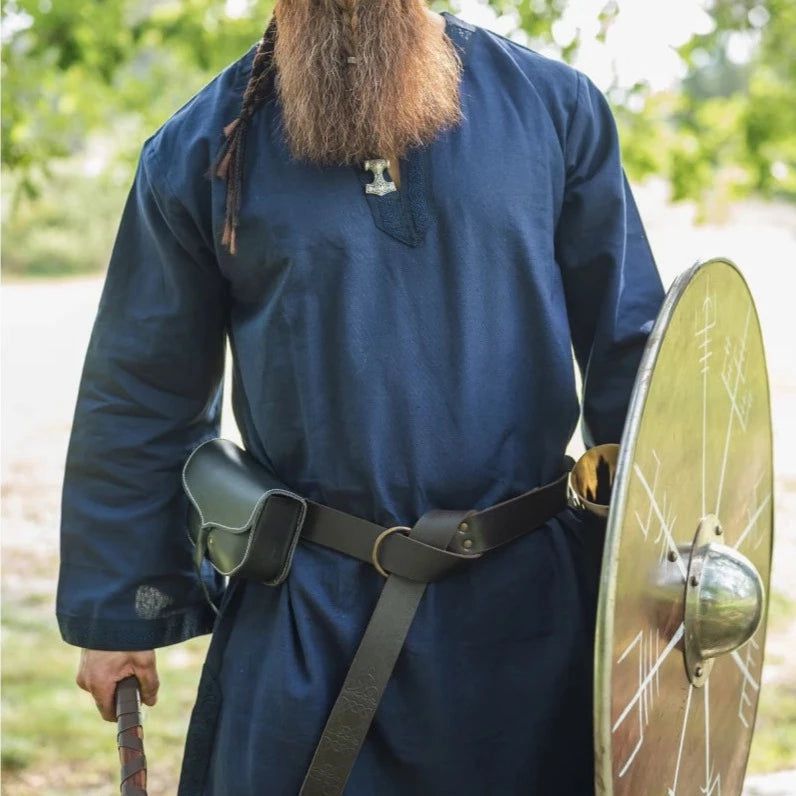 Blue Viking tunic with embroidered border, worn with belt, pouch, and shield.