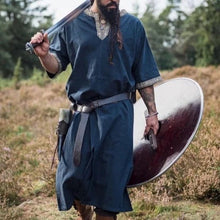 Blue Viking tunic with short sleeves, gold embroidered trim, and a warrior's sword and shield.