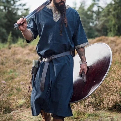 Blue Viking tunic with short sleeves, gold embroidered trim, and a warrior's sword and shield.