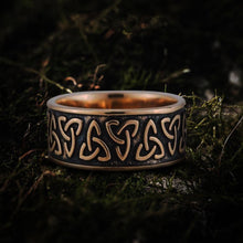 Bronze Viking Triquetra Norse ring with dark patina, showcasing intricate Celtic knotwork on moss.