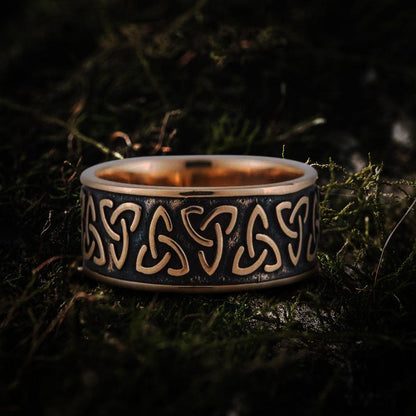 Bronze Viking Triquetra Norse ring with dark patina, showcasing intricate Celtic knotwork on moss.