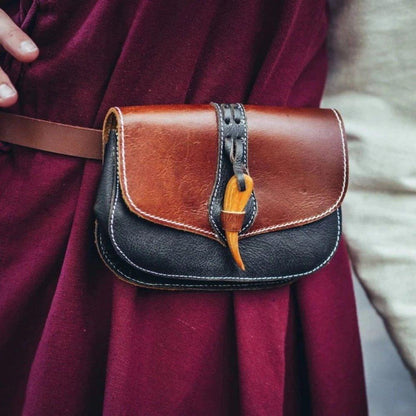 Brown and black Viking leather belt pouch with a wooden clasp closure.
