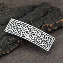 Silver Viking Celtic knotwork hair clip barrette on dark wood.