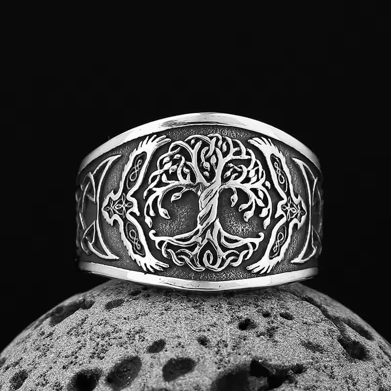 Viking silver Celtic Tree of Life ring with raven details, dark background.