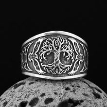 Viking silver Celtic Tree of Life ring with raven details, dark background.