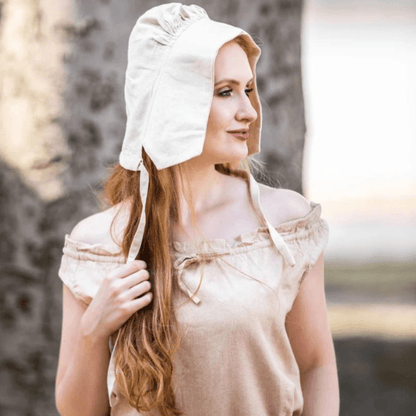 Natural cotton Viking bonnet with tie closure on a woman with long red hair.
