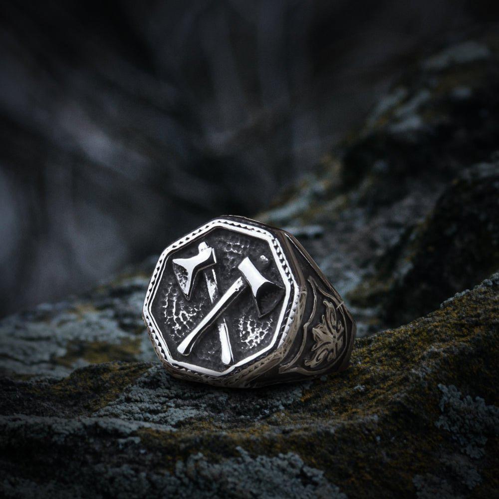Silver Viking ring with cross double battle axe design and ornate band.