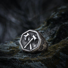 Silver Viking ring with cross double battle axe design and ornate band.