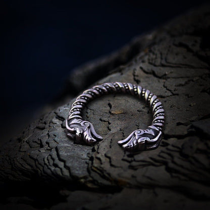 Viking dragon twisted steel torc ring with detailed dragon heads, dark silver finish.