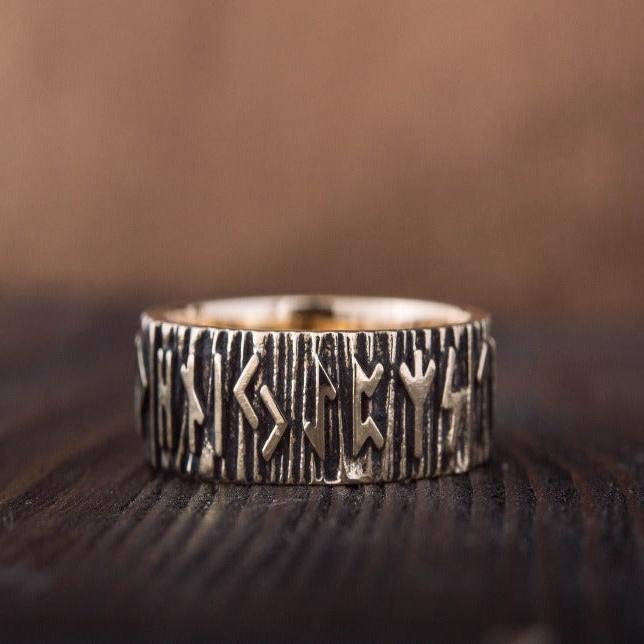 Bronze Viking ring with Elder Futhark runes and a textured bark-like band.
