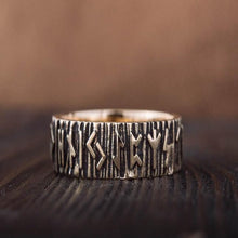 Bronze Viking ring with Elder Futhark runes and a textured bark-like band.
