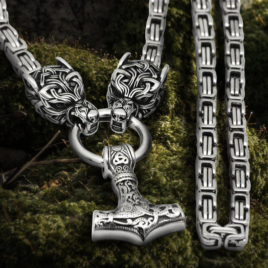 Viking Fenrir wolf head steel chain necklace with Mjolnir pendant and knotwork clasp.