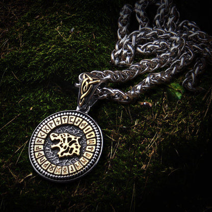 Viking gold & steel Fenrir wolf Futhark necklace on moss.