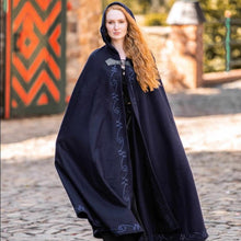 Viking hooded navy wool cloak with light blue embroidered swirls and a wolf head clasp.