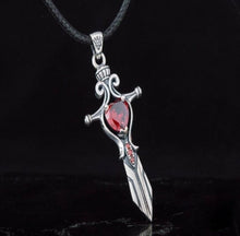 Sterling silver Viking sword pendant with a large heart-shaped red cubic zirconia and smaller red stones.