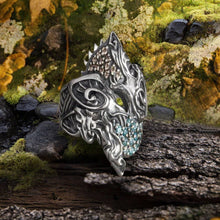 Sterling silver Viking Hati and Skoll ring with intricate Norse design, featuring brown and blue gemstones.