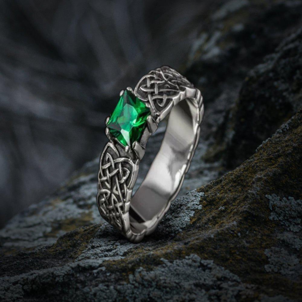 Sterling silver Viking ring with intricate Celtic knotwork and a vibrant green emerald.