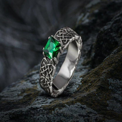 Sterling silver Viking ring with intricate Celtic knotwork and a vibrant green emerald.