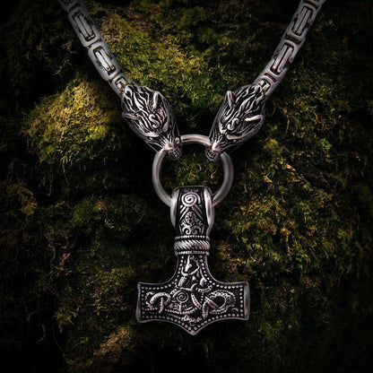 Viking Thor's Hammer Mjolnir pendant with intricate knotwork, silver wolf heads, and a thick King's Chain.