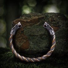 Viking stainless steel torc bracelet with knotwork wolf heads and a twisted gold and silver band.