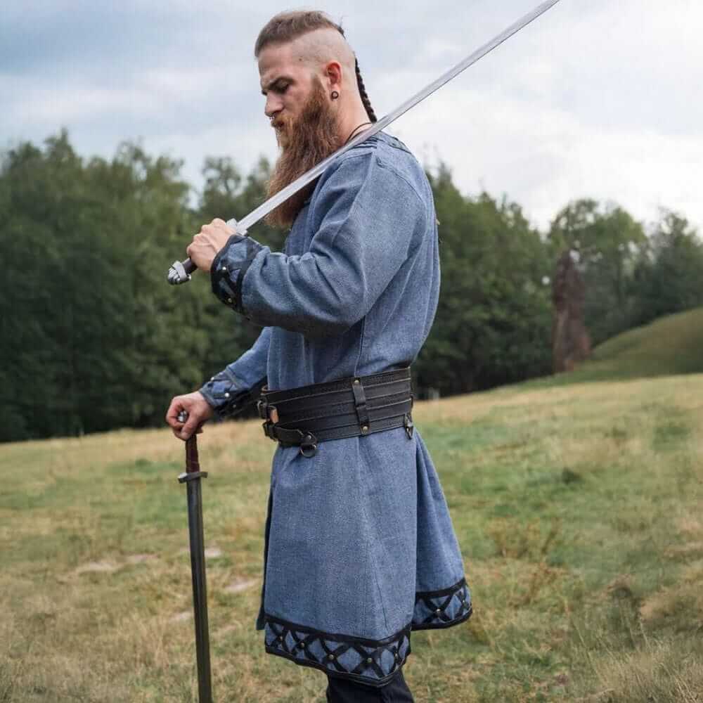 Viking tunic, blue-gray with leather trim, rivets, and decorative hem.