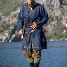 Viking tunic in blue with intricate silver embroidery, leather trim, and rivets.