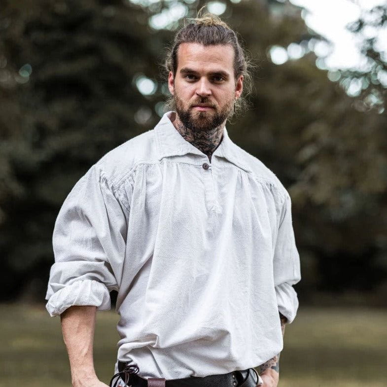 Man in a loose, light gray Viking shirt with a collar and V-neck design.