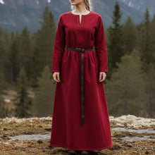 Viking rich red long-sleeved dress with a V-neck and dark belt, set against a forest backdrop.