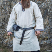 Natural cotton Viking tunic with embroidered border, knee-length, worn by a bearded man.