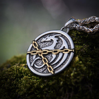 Viking Norse chained dragon talisman pendant in silver and gold-tone, on a thick silver chain.