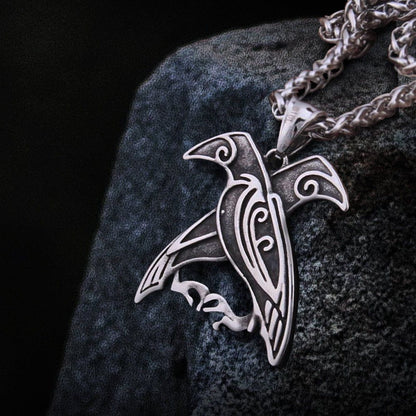 Viking silver raven totem pendant necklace featuring Hugin and Munin, with intricate Celtic knotwork.