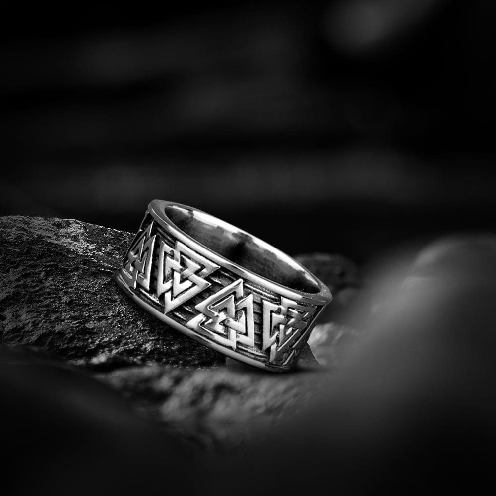 Silver steel Viking ring with intricate Valknut symbols.