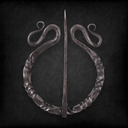 Dark twisted steel Viking penannular cloak clasp with decorative scrolls and a sharp pin.