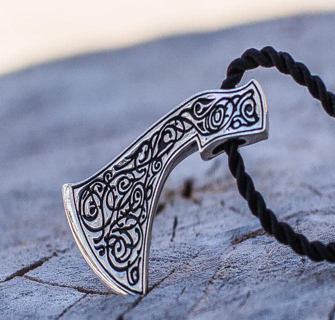 Viking Perun's Axe sterling silver pendant with intricate black ornamental engraving on a black cord.
