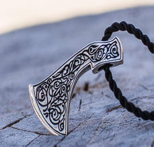 Viking Perun's Axe sterling silver pendant with intricate black ornamental engraving on a black cord.