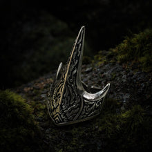 Dark silver Viking Raven Talon ring with intricate carvings on mossy wood.