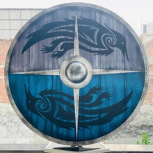24" round wooden Viking shield with blue and gray panels, featuring black raven designs and a metal boss.