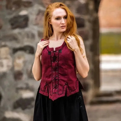 Viking red bodice with black lace, embroidery, and front lacing, worn by a woman with red hair.