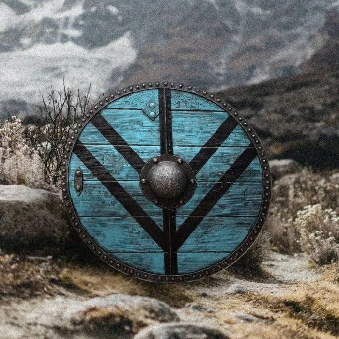 Round Viking wooden shield, distressed teal with black V-stripes and a central boss.