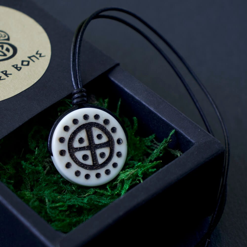 Viking Solar Cross necklace, hand-burned natural bone pendant with black cord in a gift box.