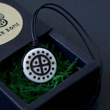 Viking Solar Cross necklace, hand-burned natural bone pendant with black cord in a gift box.