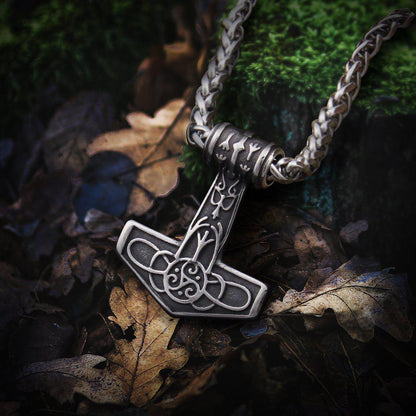 Viking steel Thor's Hammer Mjolnir necklace with delicate triskele knotwork, gold accents, and a braided chain.