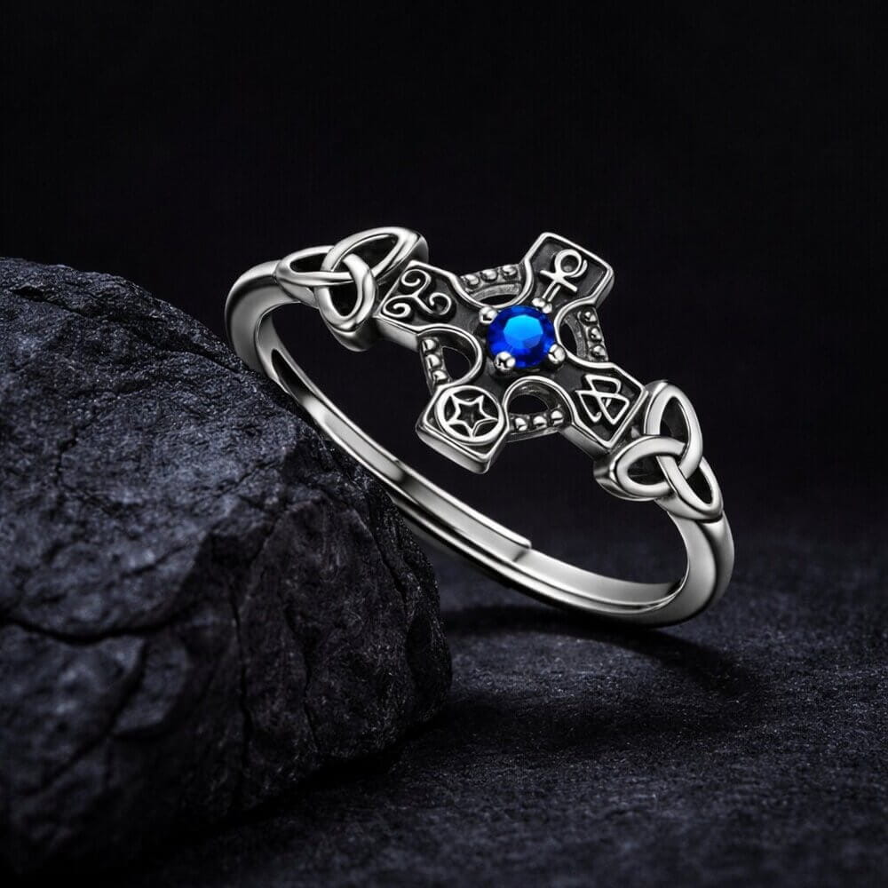 Sterling silver Viking Celtic cross ring with a vibrant blue stone and intricate knotwork.