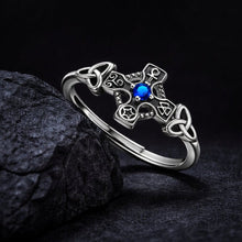 Sterling silver Viking Celtic cross ring with a vibrant blue stone and intricate knotwork.
